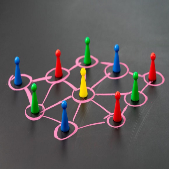 Social network, connect or relation concept, game plastic figure on colorful pastel chalk line link and connect between multiple circles or tiers on dark blackboard